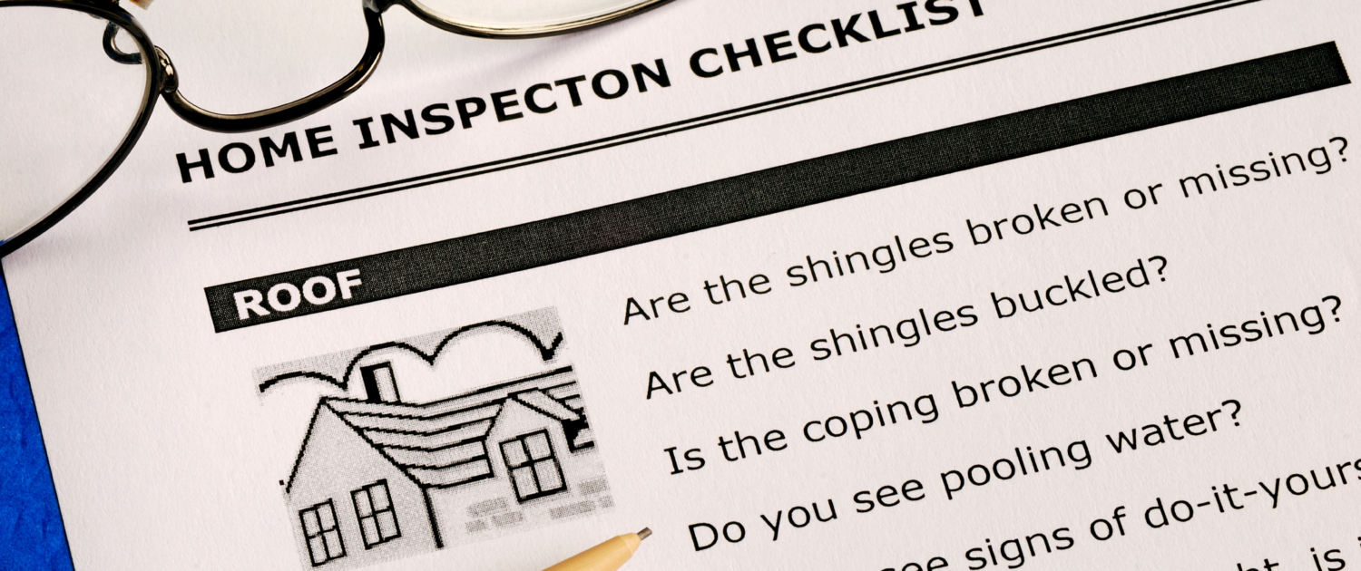 Real estate home inspection checklist and condition report Home inspection checklist with reading glasses and a pen
